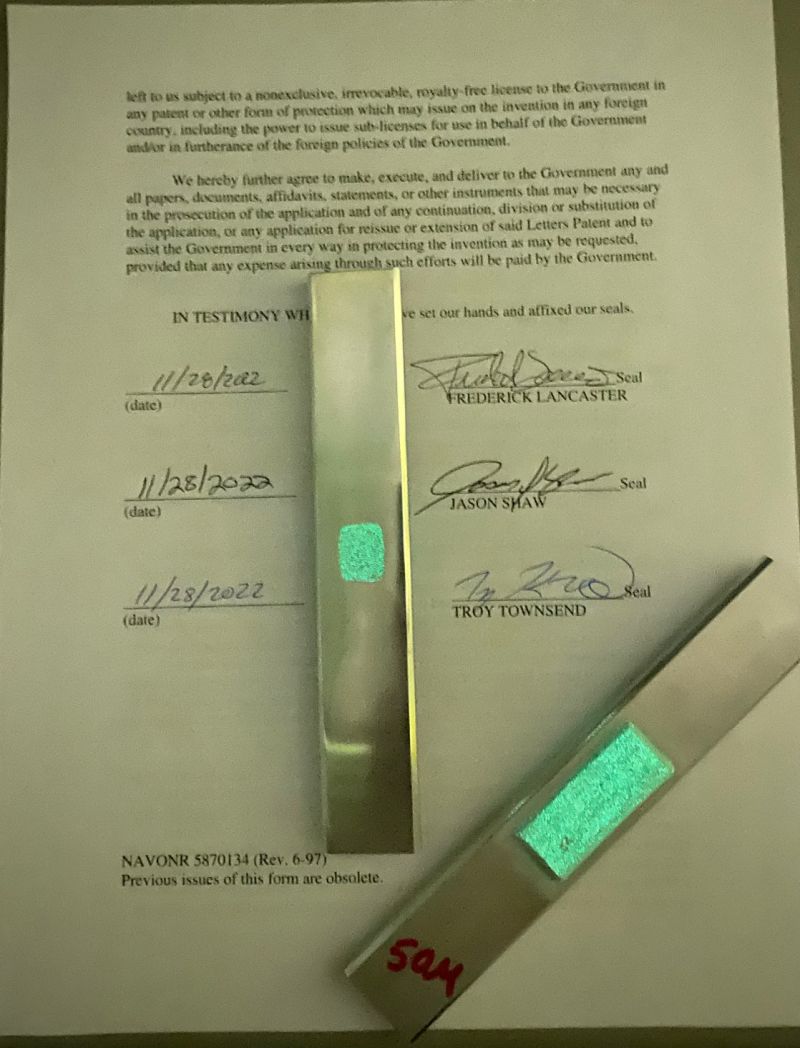 Fluorescent metal components under UV light illustrating Glow Powder applications